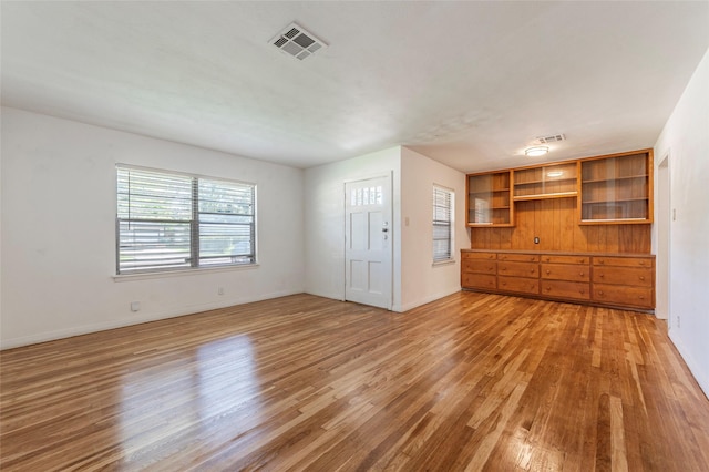 2910 John St, La Marque, TX 77568 - unfurnished living room featuring light wood-type flooring and baseboards
