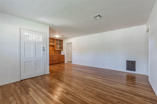2910 John St, La Marque, TX 77568 - unfurnished living room with wood-type flooring and baseboards