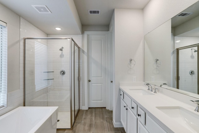20923 Grand Surprise Ct, Cypress, TX 77433 - full bath featuring a stall shower, a freestanding bath, double vanity, and recessed lighting