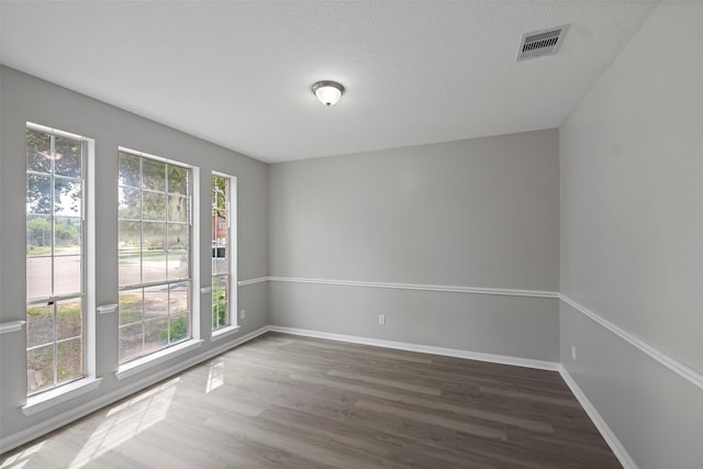 18438 Brenwood Manor Dr, Katy, TX 77449 - spare room featuring wood finished floors, baseboards, and a textured ceiling