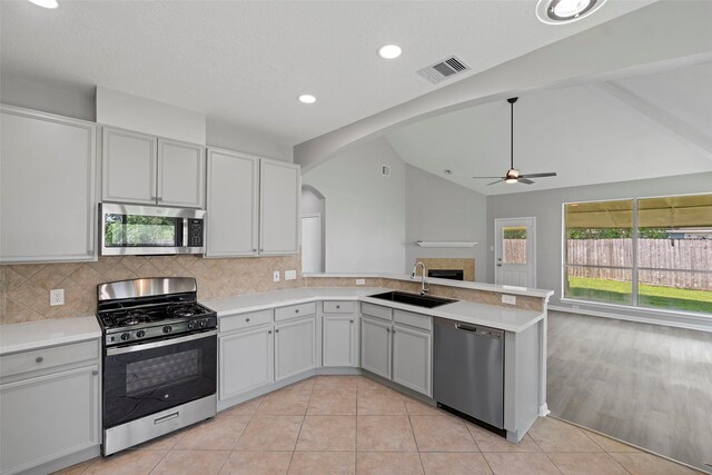 18438 Brenwood Manor Dr, Katy, TX 77449 - kitchen featuring appliances with stainless steel finishes, arched walkways, a sink, ceiling fan, and plenty of natural light
