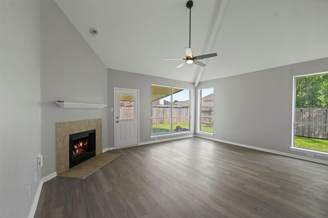 18438 Brenwood Manor Dr, Katy, TX 77449 - unfurnished living room featuring wood finished floors, a tiled fireplace, a ceiling fan, baseboards, and high vaulted ceiling
