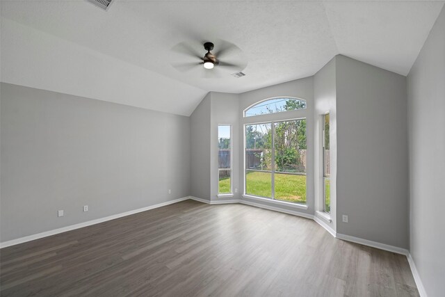 18438 Brenwood Manor Dr, Katy, TX 77449 - empty room with vaulted ceiling, ceiling fan, wood finished floors, and baseboards