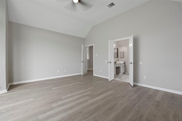 18438 Brenwood Manor Dr, Katy, TX 77449 - unfurnished bedroom with wood finished floors, baseboards, vaulted ceiling, ensuite bathroom, and ceiling fan