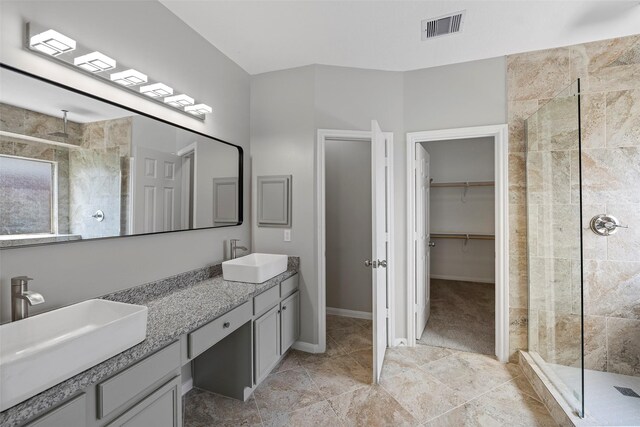 18438 Brenwood Manor Dr, Katy, TX 77449 - full bathroom with a stall shower, a spacious closet, double vanity, and baseboards