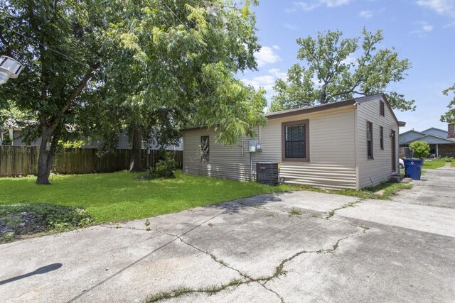 1202 13th St N, Texas City, TX 77590 - view of front of home with central AC, concrete driveway, and a patio area