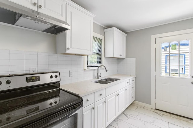 1202 13th St N, Texas City, TX 77590 - kitchen with stainless steel electric range, under cabinet range hood, a sink, white cabinets, and light marble finish floors