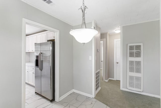 1202 13th St N, Texas City, TX 77590 - unfurnished dining area featuring a heating unit, light marble finish flooring, crown molding, and baseboards