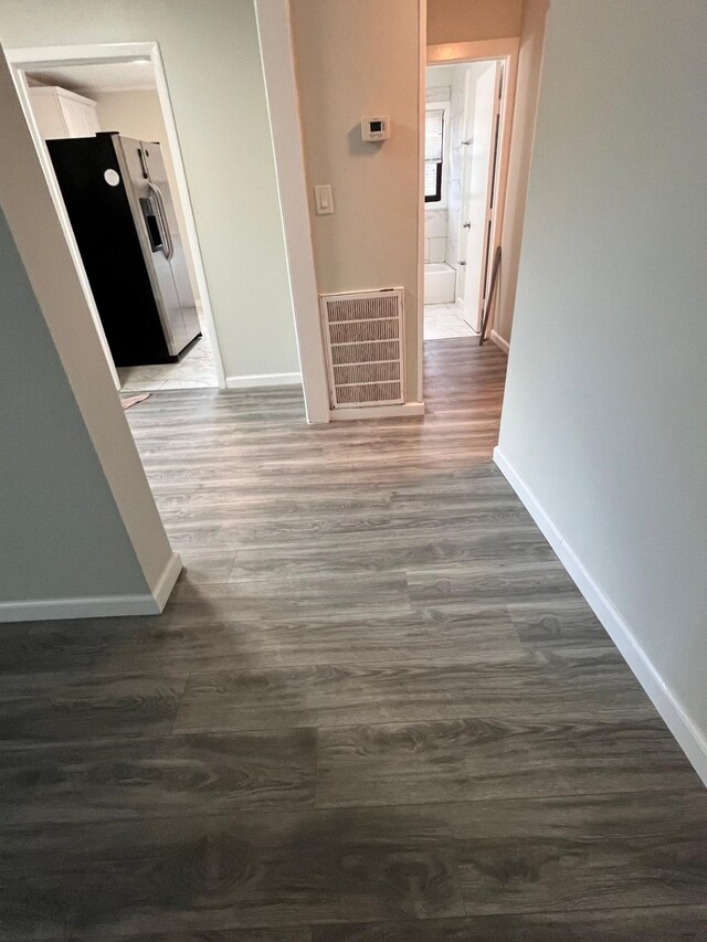 1202 13th St N, Texas City, TX 77590 - hallway with baseboards and dark wood-type flooring