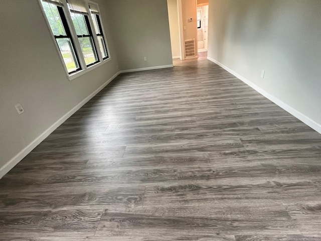 1202 13th St N, Texas City, TX 77590 - unfurnished room with dark wood-style floors and baseboards