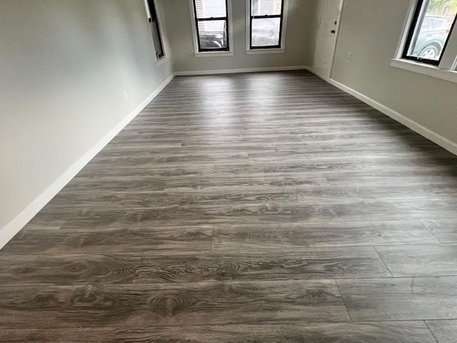 1202 13th St N, Texas City, TX 77590 - unfurnished room with healthy amount of natural light, dark wood-type flooring, and baseboards
