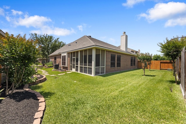 16506 Shimmering Lake Dr, Cypress, TX 77433 - rear view of house featuring brick siding, a sunroom, a chimney, and a shingled roof