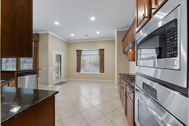 16506 Shimmering Lake Dr, Cypress, TX 77433 - kitchen with appliances with stainless steel finishes, crown molding, dark stone countertops, baseboards, and recessed lighting