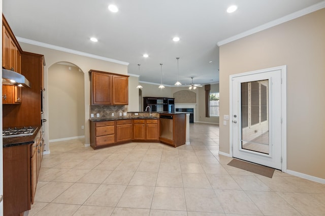 16506 Shimmering Lake Dr, Cypress, TX 77433 - kitchen featuring a ceiling fan, arched walkways, appliances with stainless steel finishes, a peninsula, and dark countertops