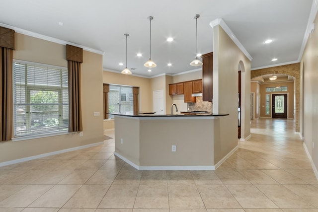 16506 Shimmering Lake Dr, Cypress, TX 77433 - kitchen featuring arched walkways, dark countertops, ornamental molding, light tile patterned flooring, and baseboards