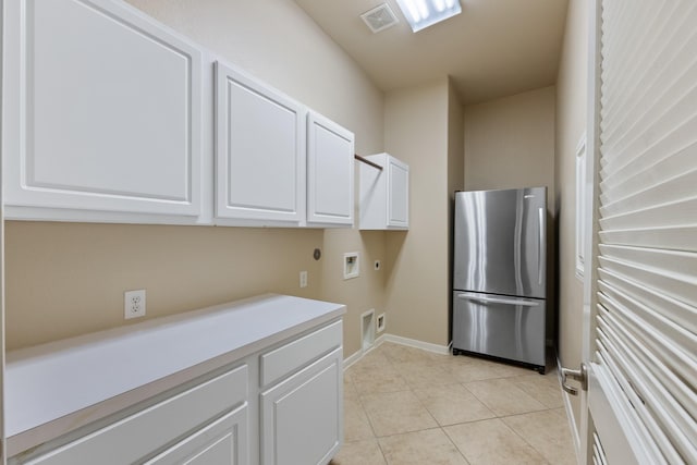 16506 Shimmering Lake Dr, Cypress, TX 77433 - clothes washing area with hookup for an electric dryer, washer hookup, cabinet space, light tile patterned floors, and baseboards