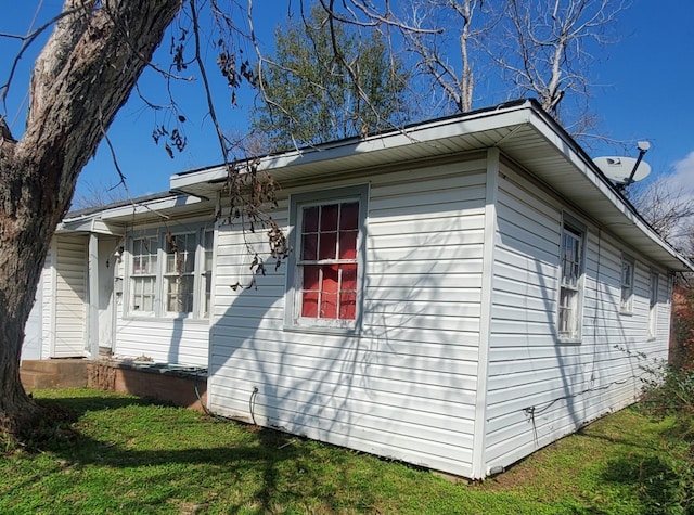 view of side of home featuring a yard