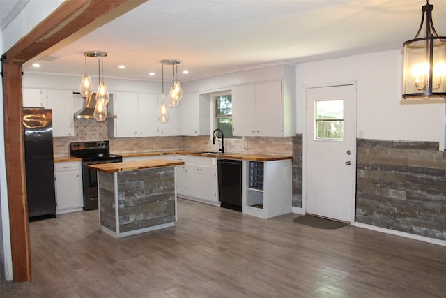 1314 Hooks St, Crockett, TX 75835 - kitchen with butcher block counters, black appliances, wall chimney exhaust hood, white cabinetry, and dark wood-type flooring