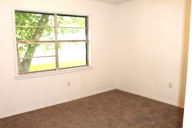 1314 Hooks St, Crockett, TX 75835 - empty room with dark carpet and baseboards