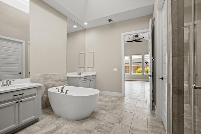 10630 Hazel Hills Dr, Cypress, TX 77433 - full bathroom featuring two vanities, marble look tile flooring, a soaking tub, a ceiling fan, and recessed lighting