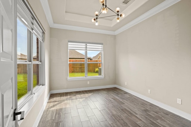 10630 Hazel Hills Dr, Cypress, TX 77433 - empty room with a chandelier, wood finished floors, a raised ceiling, ornamental molding, and baseboards