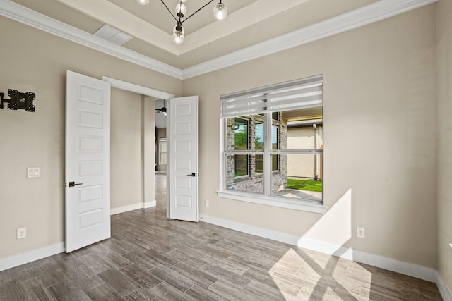 10630 Hazel Hills Dr, Cypress, TX 77433 - empty room featuring crown molding, dark wood-style flooring, a tray ceiling, and baseboards