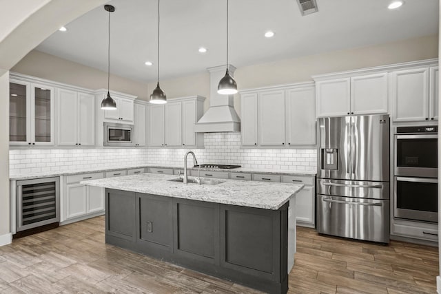 10630 Hazel Hills Dr, Cypress, TX 77433 - kitchen with beverage cooler, stainless steel appliances, a sink, white cabinetry, and tasteful backsplash