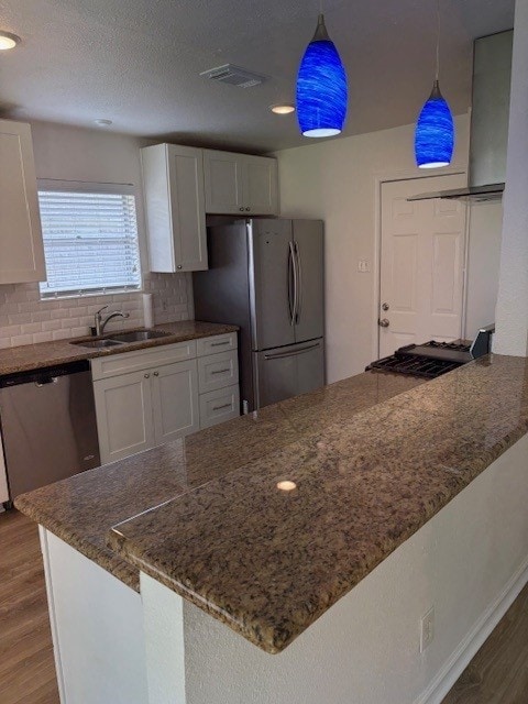 3213 Whitesail Dr, League City, TX 77573 - kitchen with stainless steel appliances, white cabinetry, wood finished floors, and recessed lighting