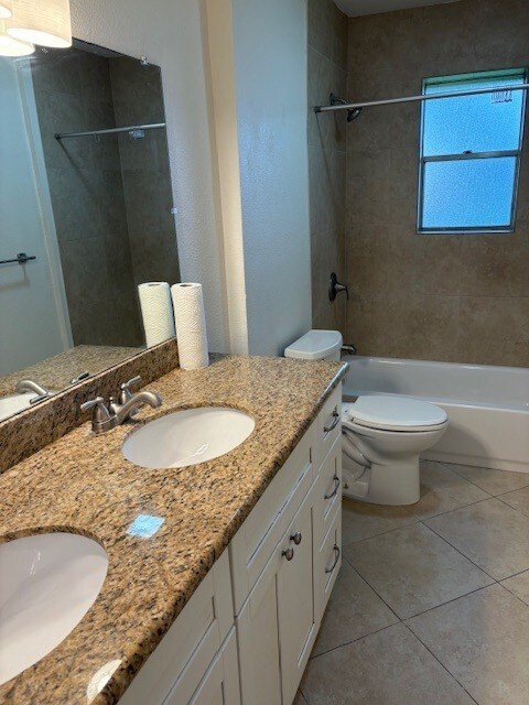 3213 Whitesail Dr, League City, TX 77573 - full bath with double vanity, shower / bathtub combination, and tile patterned flooring