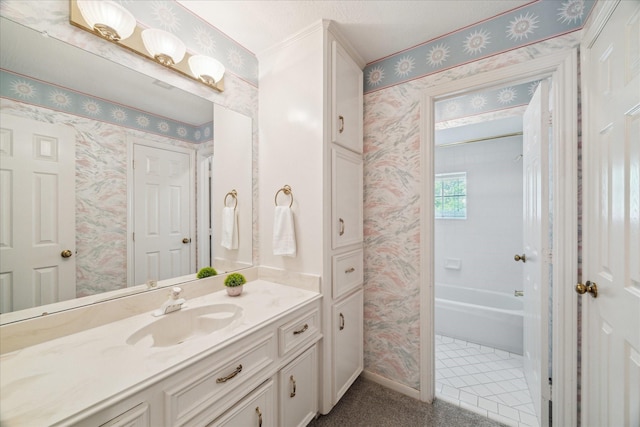 bathroom featuring wallpapered walls, vanity, baseboards, and shower / bath combination