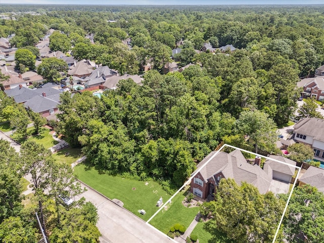 aerial view of residential area featuring a heavily wooded area and property boundaries highlighted