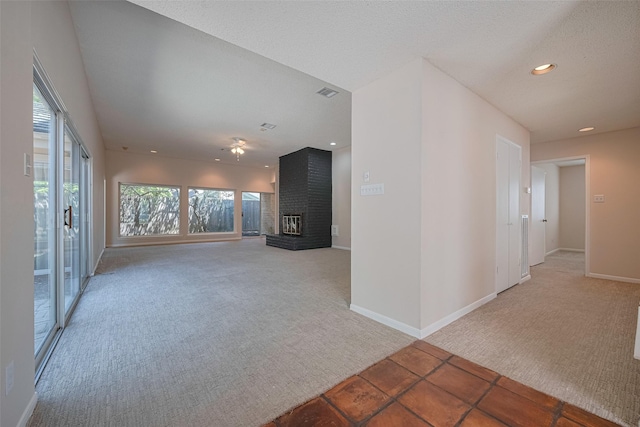 unfurnished living room featuring light carpet, plenty of natural light, a fireplace, baseboards, and recessed lighting