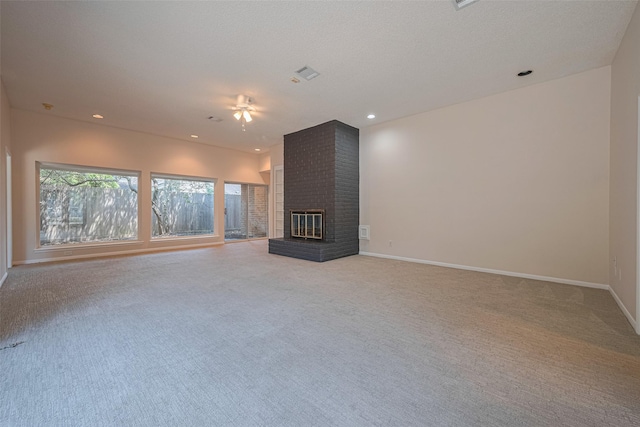 unfurnished living room featuring light carpet, baseboards, a brick fireplace, ceiling fan, and recessed lighting
