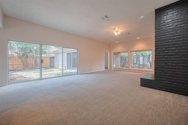carpeted empty room with baseboards, a textured ceiling, and ceiling fan