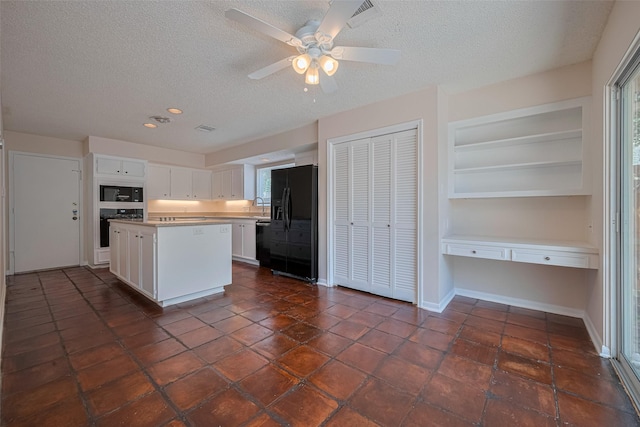 kitchen with black appliances, a textured ceiling, white cabinetry, a center island, and recessed lighting