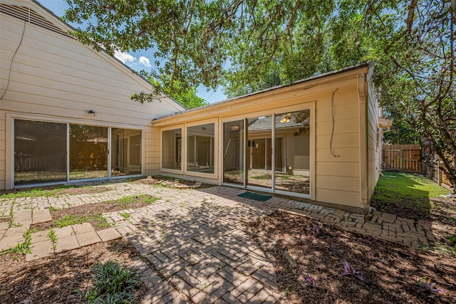 rear view of house featuring a patio area and fence