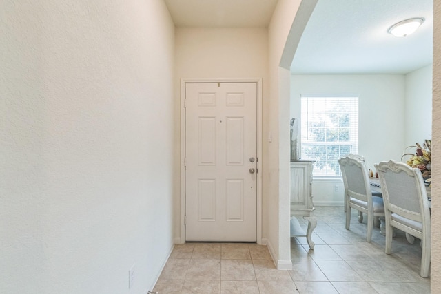 9526 Opal Gates Dr, Rosharon, TX 77583 - entrance foyer featuring arched walkways, light tile patterned floors, and baseboards