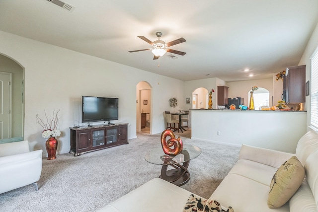 9526 Opal Gates Dr, Rosharon, TX 77583 - living area featuring arched walkways, light colored carpet, and ceiling fan