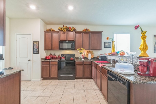 9526 Opal Gates Dr, Rosharon, TX 77583 - kitchen featuring black appliances, a sink, dark stone countertops, light tile patterned floors, and recessed lighting