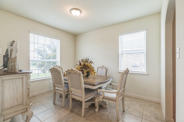 9526 Opal Gates Dr, Rosharon, TX 77583 - dining area with baseboards and light tile patterned flooring