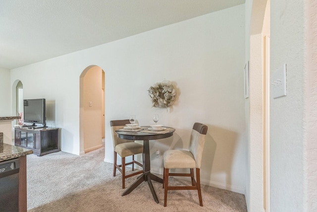 9526 Opal Gates Dr, Rosharon, TX 77583 - dining area with arched walkways, carpet flooring, and baseboards