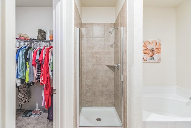 9526 Opal Gates Dr, Rosharon, TX 77583 - full bathroom with a walk in closet, a shower stall, and a garden tub