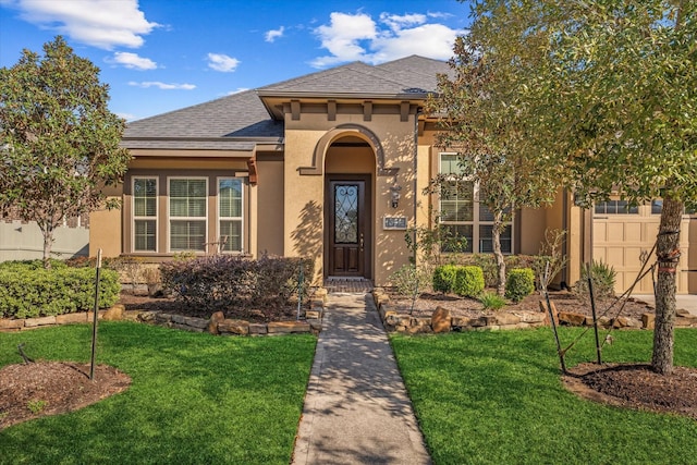 10442 Lake Palmetto Dr, Conroe, TX 77385 - mediterranean / spanish home with stucco siding, a front yard, roof with shingles, and an attached garage