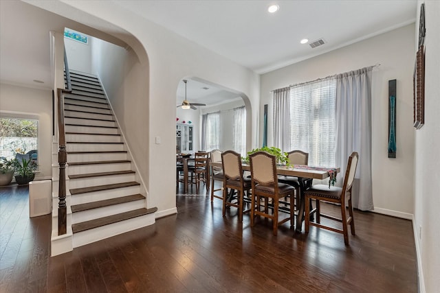 10442 Lake Palmetto Dr, Conroe, TX 77385 - dining room featuring dark wood finished floors, a ceiling fan, stairway, arched walkways, and recessed lighting