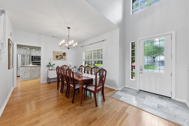 4510 Hazelton St, Houston, TX 77035 - dining space with a chandelier, light wood-type flooring, and baseboards