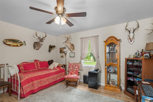 19769 State Highway 21 E, Grapeland, TX 75844 - bedroom featuring wood finished floors, a ceiling fan, and baseboards