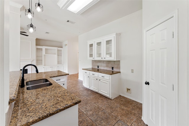 3418 Mcmahon Way, Missouri City, TX 77459 - kitchen with a sink, tasteful backsplash, dark stone counters, and glass insert cabinets