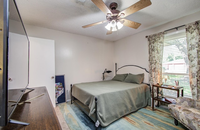 12211 3rd St, Santa Fe, TX 77510 - bedroom with a textured ceiling and a ceiling fan