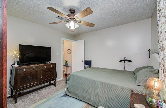 12211 3rd St, Santa Fe, TX 77510 - carpeted bedroom featuring a ceiling fan, a textured ceiling, and baseboards