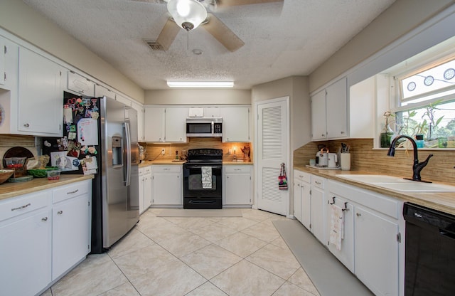 12211 3rd St, Santa Fe, TX 77510 - kitchen featuring black appliances, a sink, backsplash, ceiling fan, and light countertops